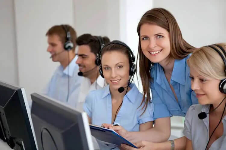 At a call center Smiling customer service representative