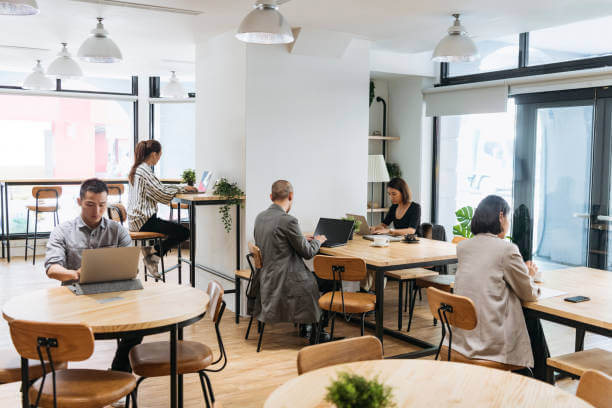 freelancers working on computers in modern collaborative spaces