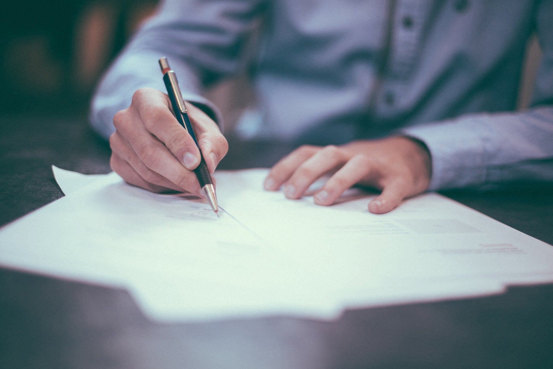 Working employee with pen and paper